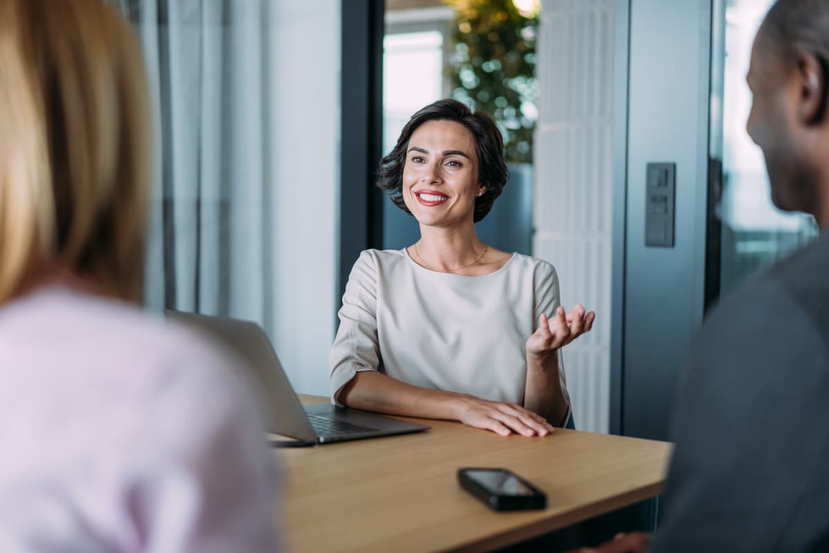 Adviser speaking to a man and women