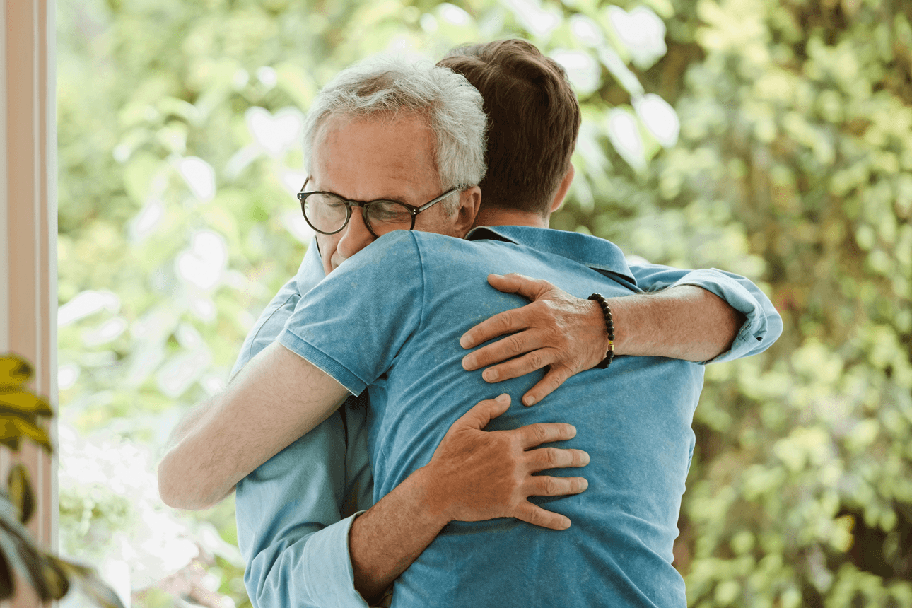 Two men hugging