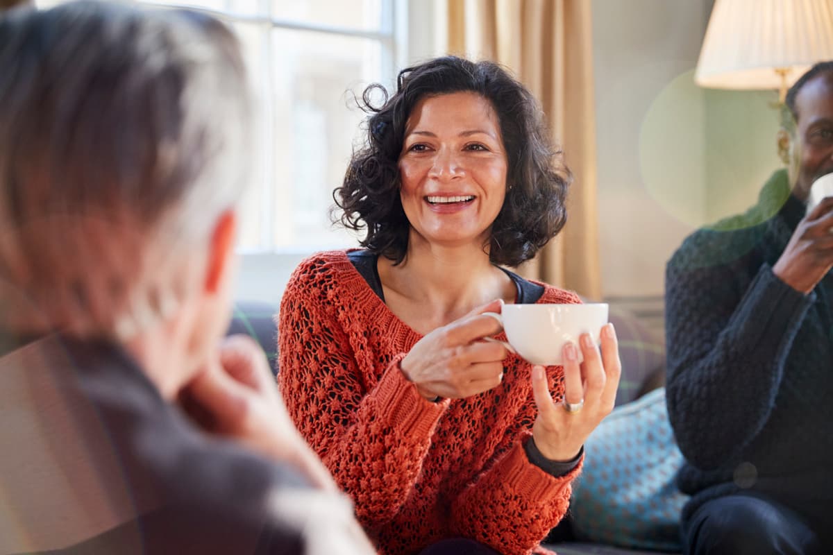Women smiling holding a mug