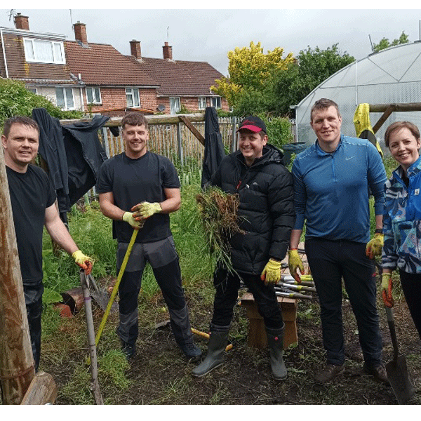4 men and 1 women volunterring in some gardens in Bristol