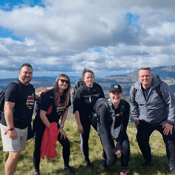 Colleagues at the top of a hill on a charity walk