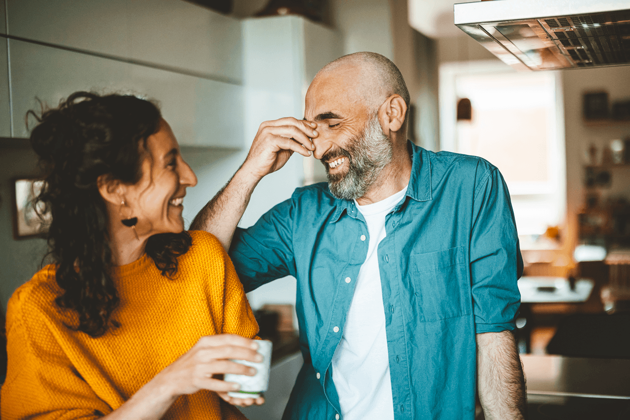 Man and women laughing in the kitchen